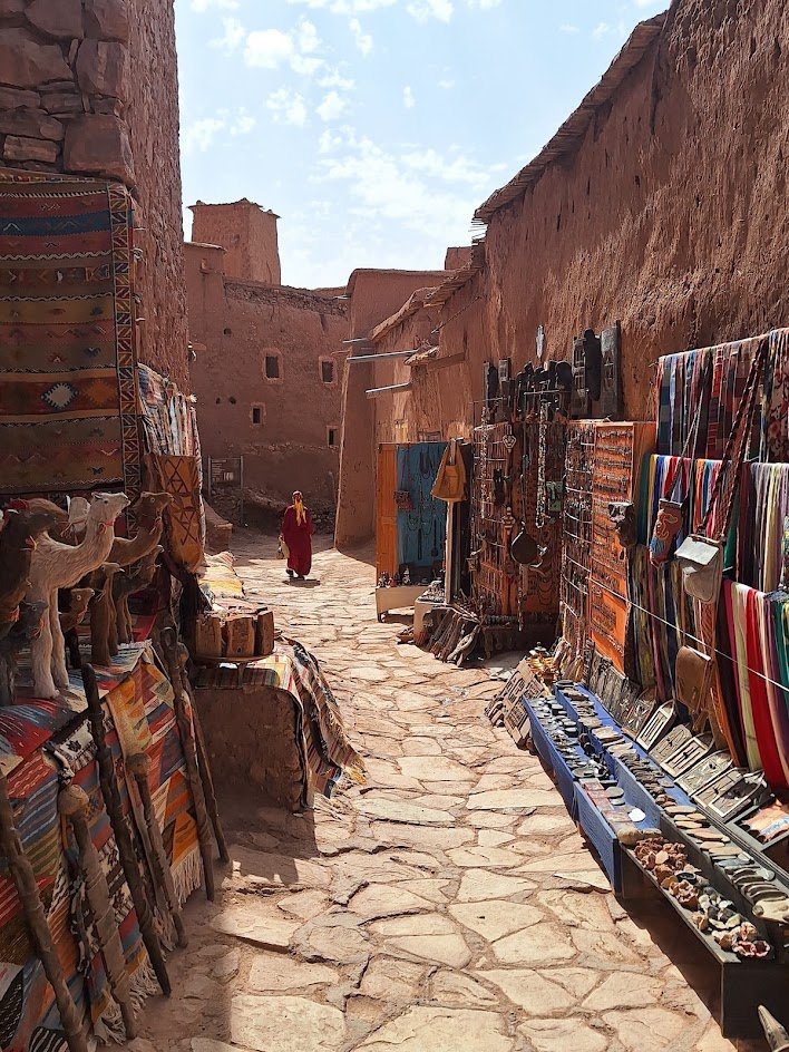 Market lane between earthen walls in Aït Benhaddou